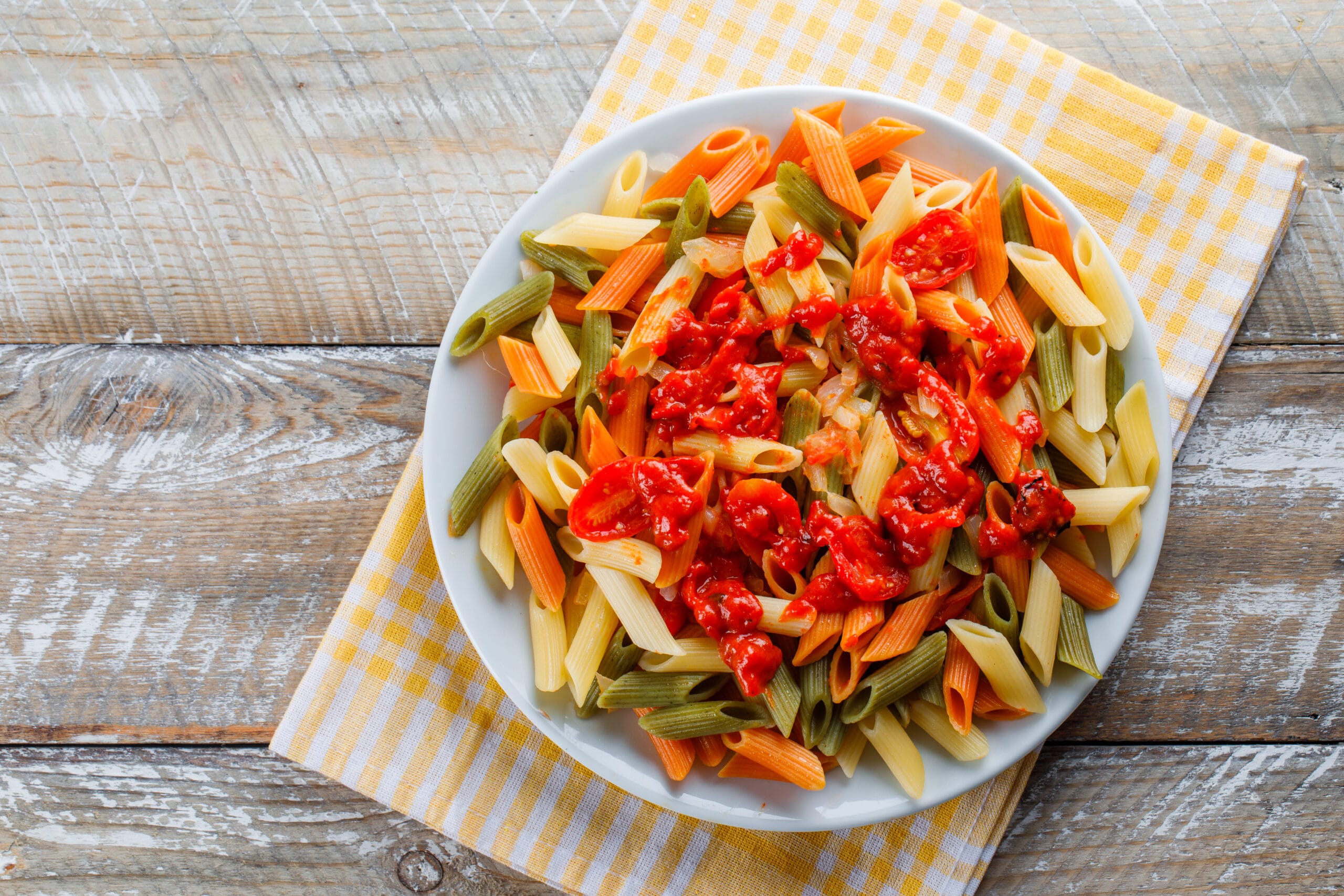 Close-up of ditalini pasta in a white bowl, highlighting its thimble-shaped tubes perfect for a variety of dishes