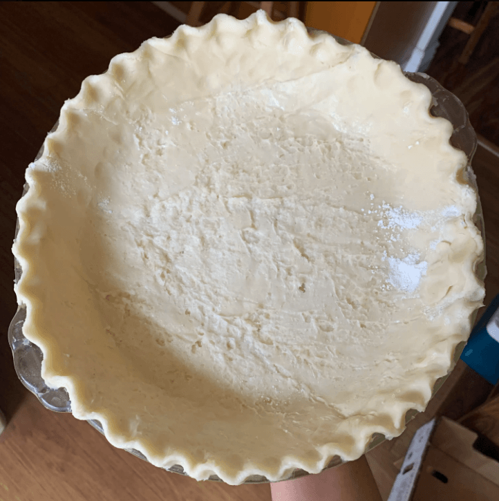 Golden, flaky pie crust with visible layers, baked to perfection for both sweet and savory dishes.