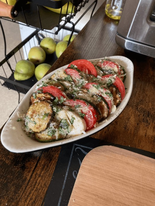 Cooked zucchini slices with a golden, caramelized exterior on a plate