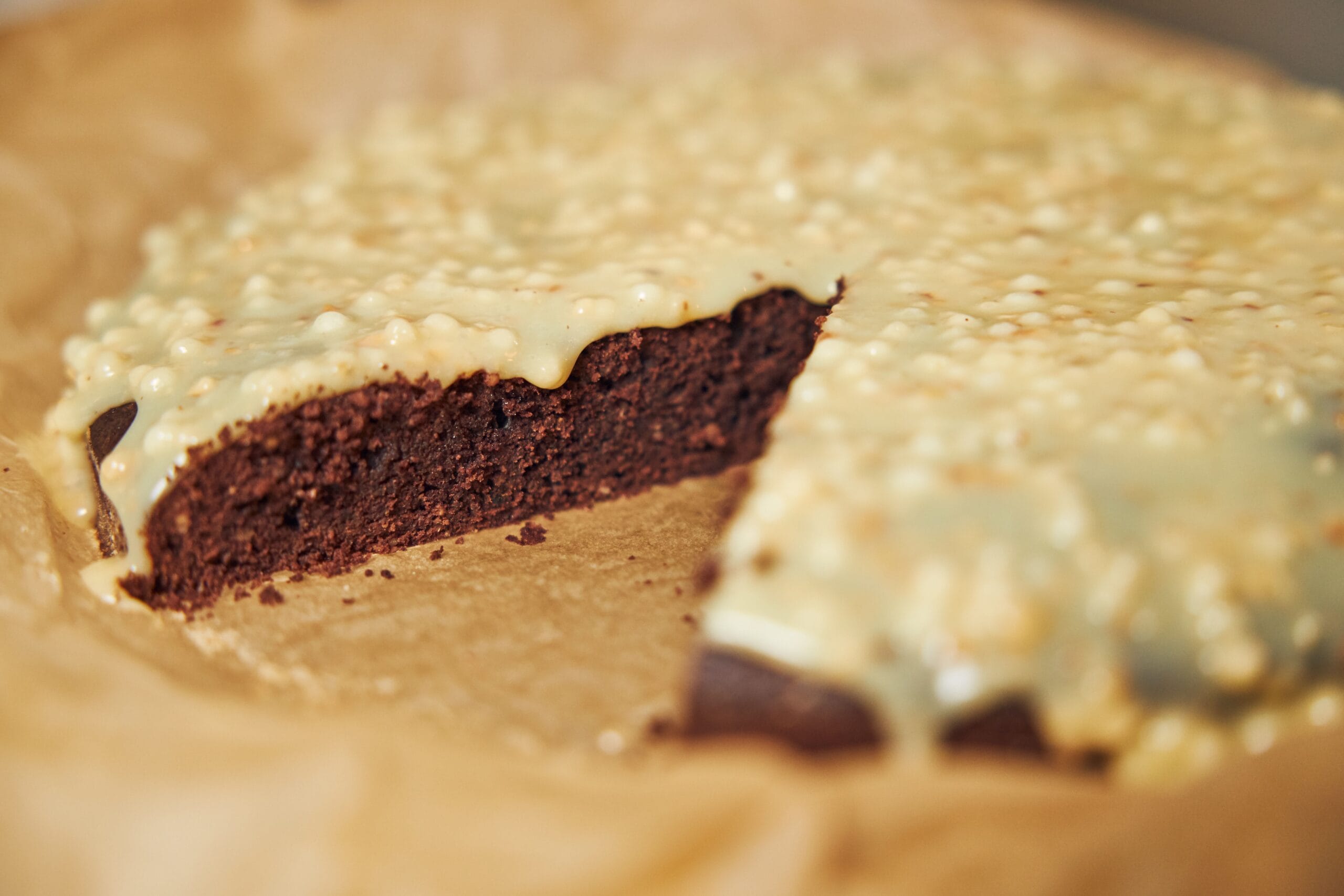 Rich chocolate pie with a graham cracker crust, topped with whipped cream and chocolate shavings on a white plate.