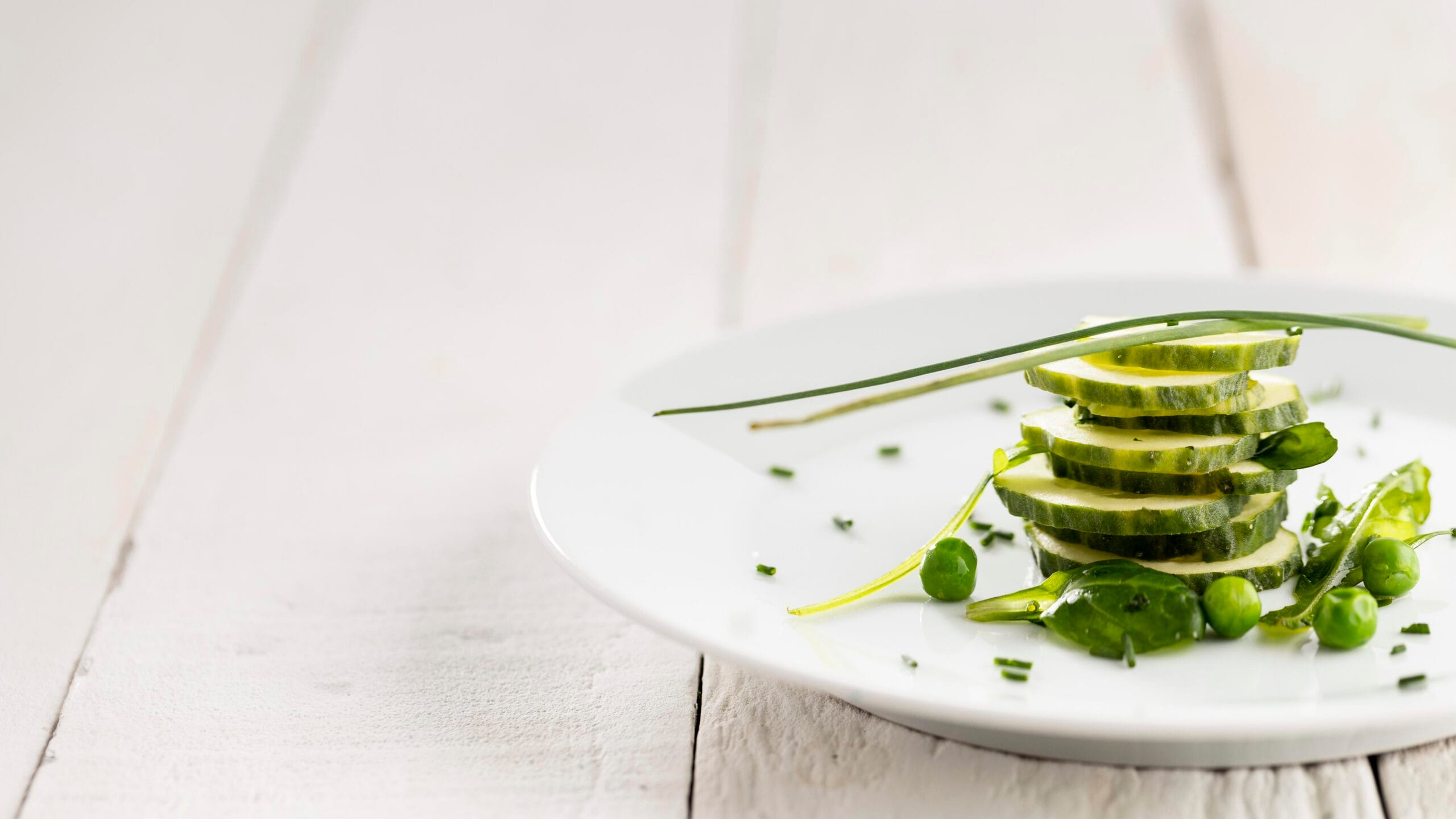 Sautéed zucchini slices in a skillet with herbs