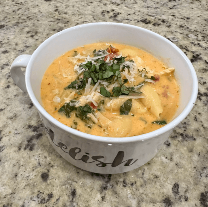 A plate of creamy Marry Me Chicken with fresh basil garnish.