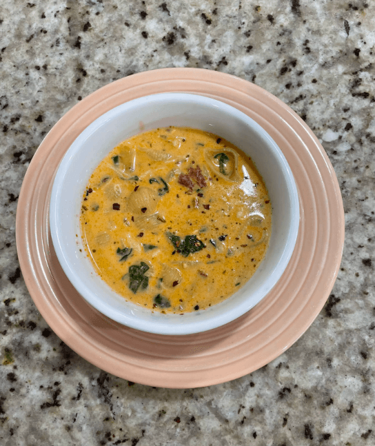 A plate of Marry Me Pasta garnished with fresh basil and Parmesan cheese.