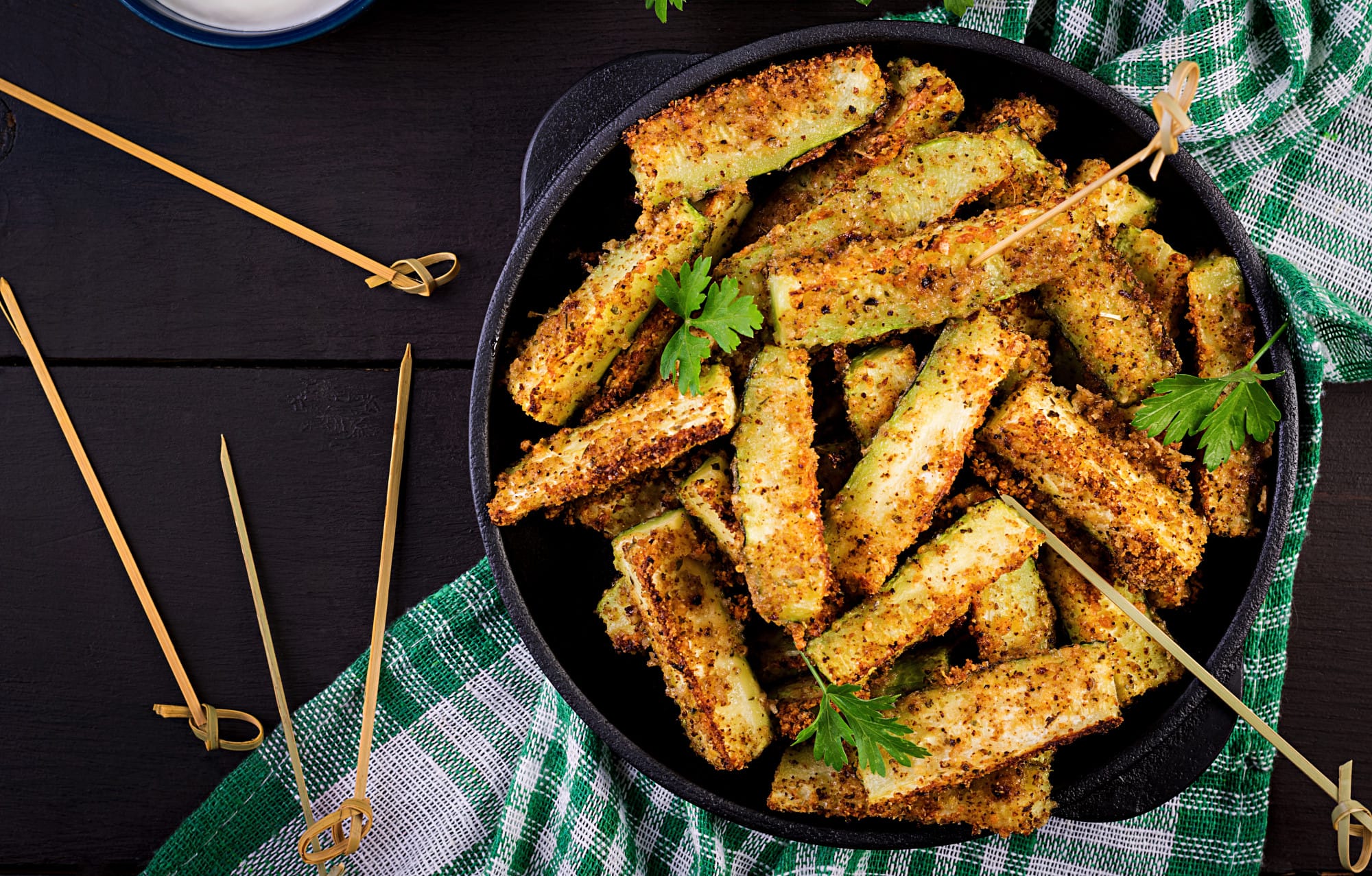 A plate of Parmesan crusted zucchini slices garnished with parsley