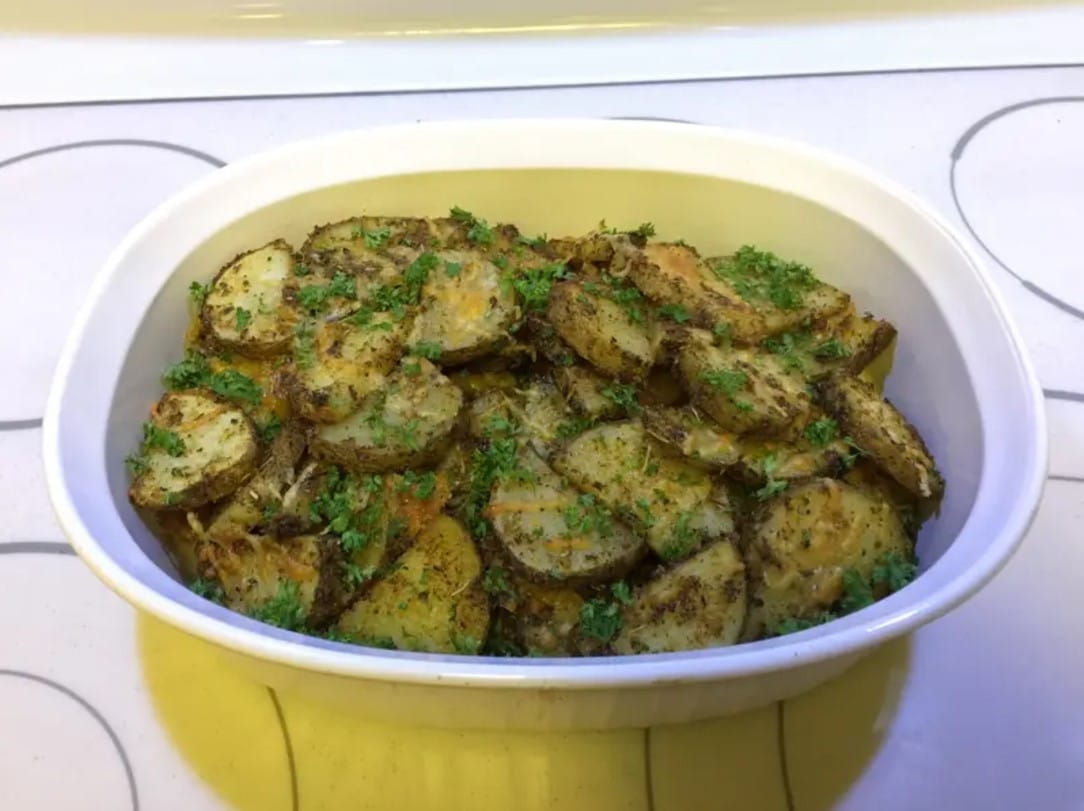 Crispy parmesan crusted zucchini slices in an air fryer basket.